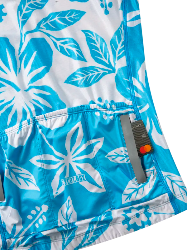 Blue cycling jersey with white Hawaiian floral pattern back pockets