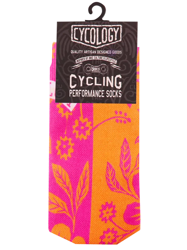 Cycling performance socks with pink and orange floral pattern on packaging, featuring Cycology branding.