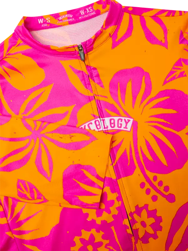 Brightly colored jersey with pink and orange floral patterns and 'Cycology' branding.