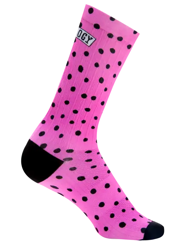 A single bright pink crew cycling sock with a black polka dot pattern, black toe and heel, and a white ribbed cuff, shown on a plain white background.