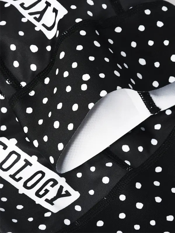 Black polka dot fabric with a metallic object and 'Sculptology' branding.