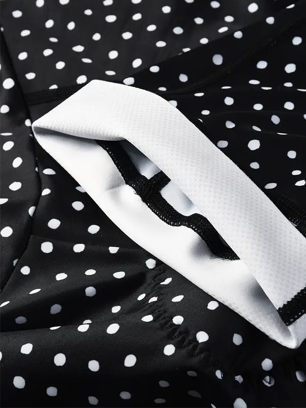 Close-up of a black polka dot fabric with a white elastic band.