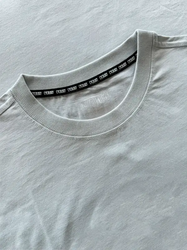 Close-up of a gray t-shirt with a black label on the collar.