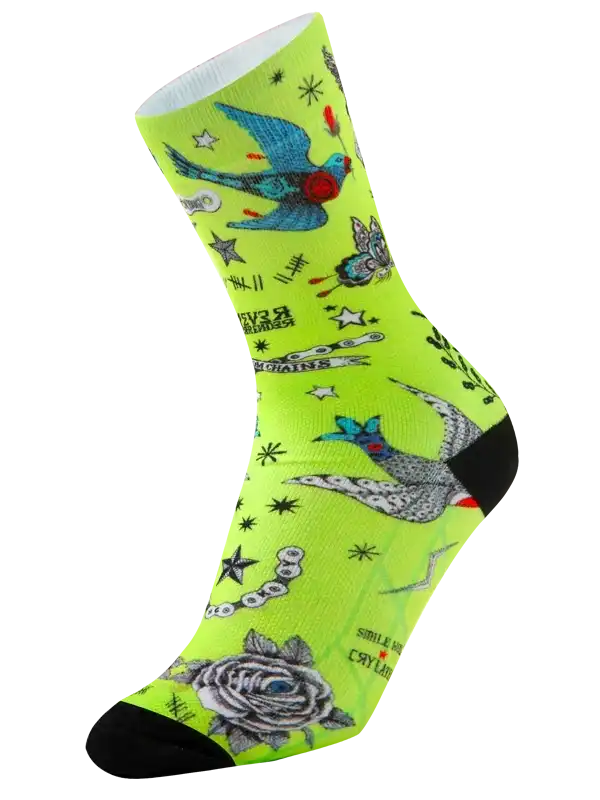 Neon green cycling socks with bird, rose, and star tattoo-style print, black toe and heel