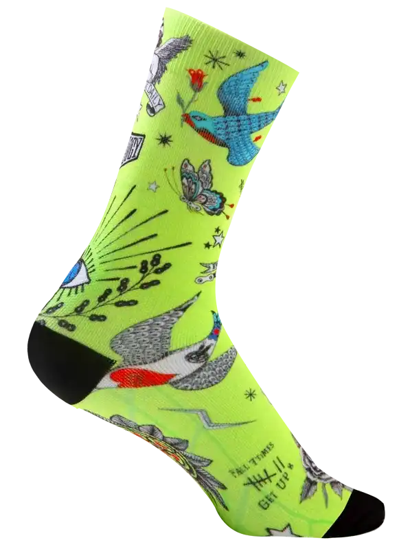 Vibrant neon green cycling sock with tattoo-style birds, butterflies, and stars for men's and women's bike rides.