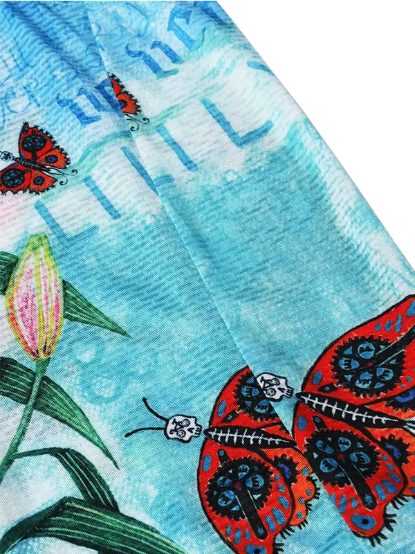 Colorful butterfly design on a blue background with green leaves.