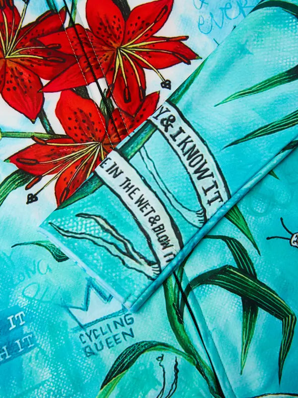 Teal cycling jersey with red floral design and text