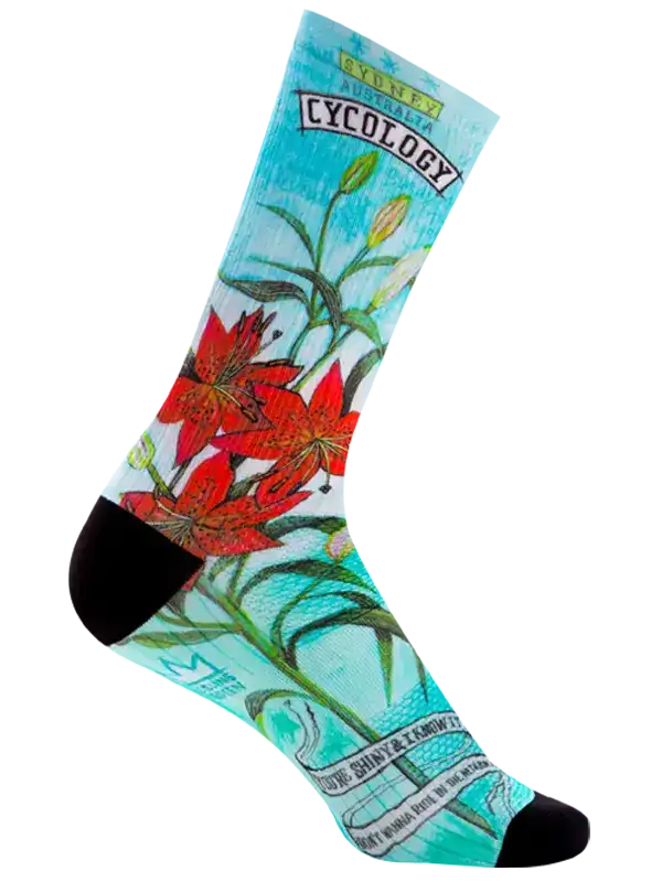 A single crew sock with a light blue background featuring a red lily flower illustration, green stems, and text including 'CYCOLOGY' and 'M. Stanley'.