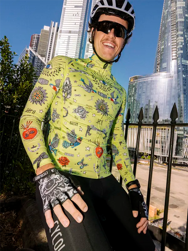 Person wearing a Colorful  lime men's long sleeve cycling jersey with intricate designs in an urban setting