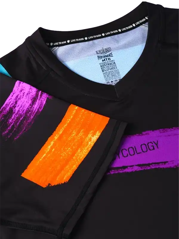 Black cycling jersey with vibrant purple and orange brushstroke design, performance fabric, MTB style