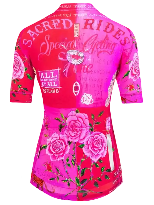 Women's pink cycling jersey with rose print and 'Sacred Rides' text, ideal for road biking adventures.