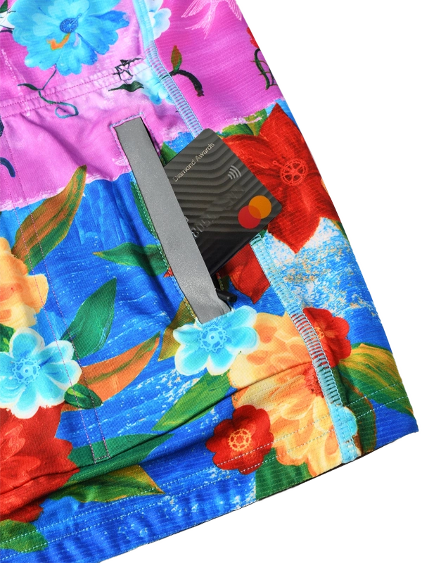 Colorful women's long sleeve  cycling jersey with floral design and 'Cycology' branding on a pink and blue background