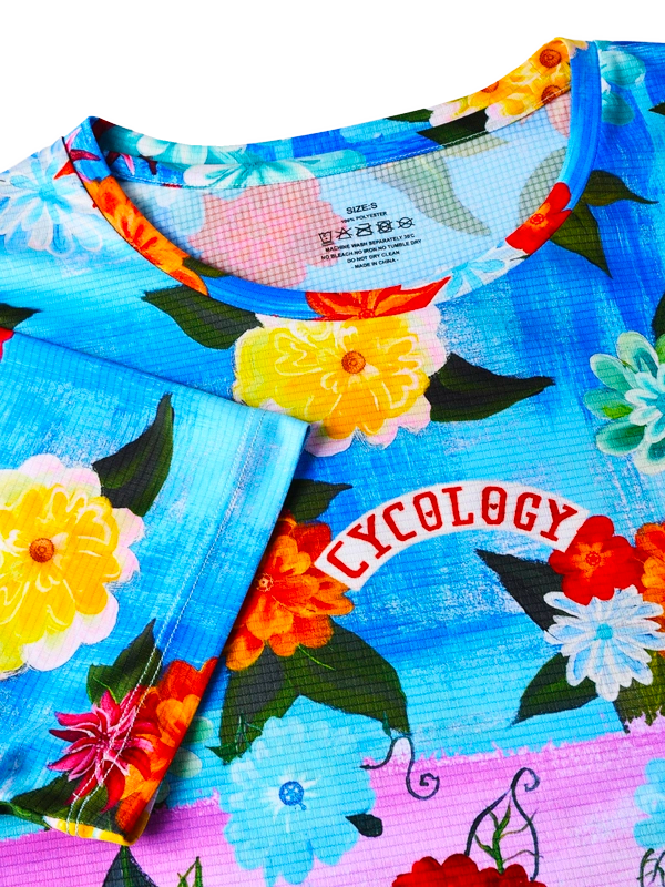 Colorful floral-patterned  t shirt with 'Cycology' branding 