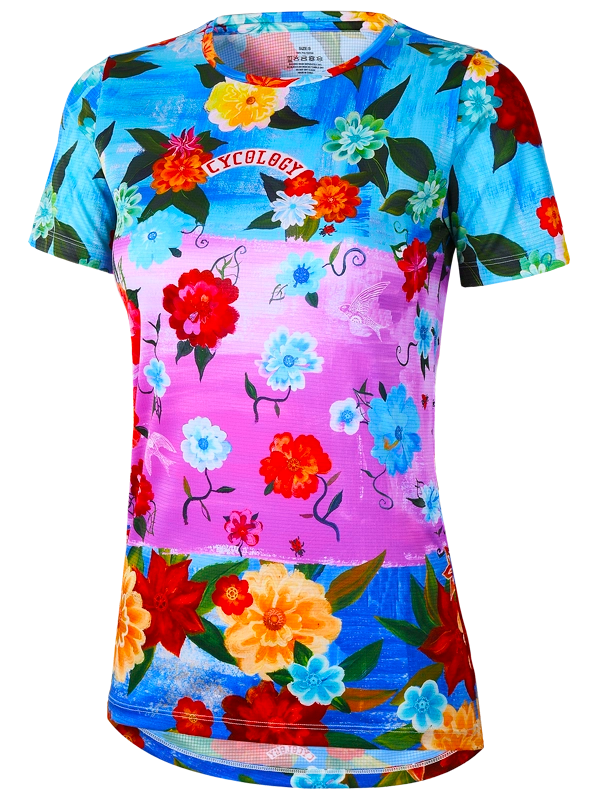 Colorful women's floral tech  t-shirt with red, yellow, and blue flowers on a multi coloured background