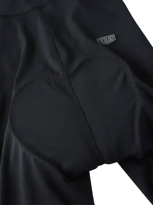 Black cycling bib shorts with padded chamois and Cycology logo, designed for comfort and performance.