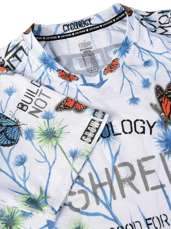 Men's cycling jersey with butterfly and plant print, breathable fabric, bold graphics for road biking
