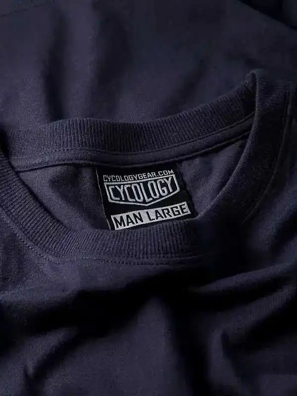 Cycology men's large cycling t-shirt tag with brand logo and size detail on dark fabric