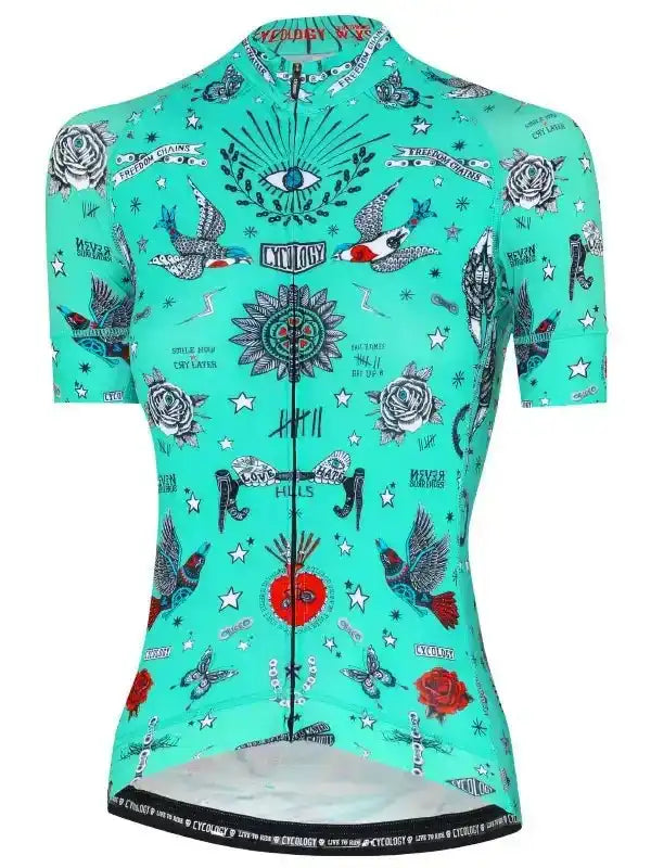 Women's turquoise cycling jersey with tattoo-style roses, birds, and stars print for road biking