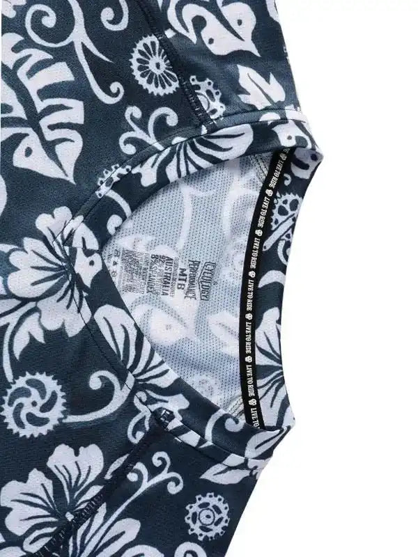 Black and white floral cycling jersey with gear pattern, breathable mesh lining, and performance fabric details