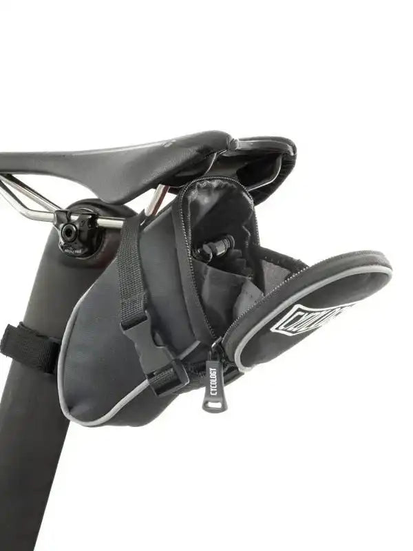 Black cycling saddle bag with zippered compartment attached to bike seat, ideal for storage on rides