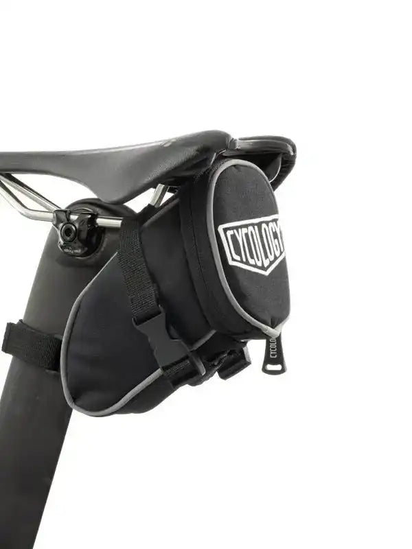 Black Cycology saddle bag attached to bike seat, ideal for cycling gear storage