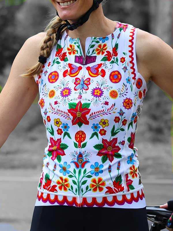 Woman wearing colorful floral cycling jersey with zipper, designed for bike rides and outdoor fitness.
