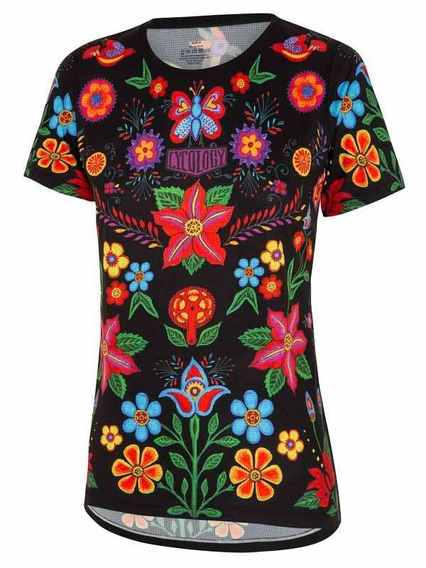 Women's cycling jersey with vibrant floral and butterfly print on black background, breathable mesh hem