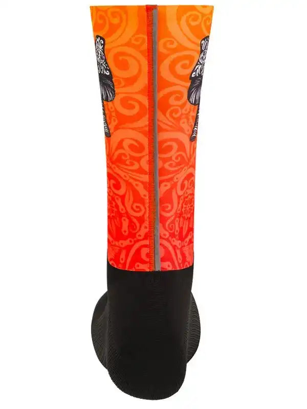 Vibrant orange cycling sock with black swirl pattern and reflective stripe, designed for performance and style.