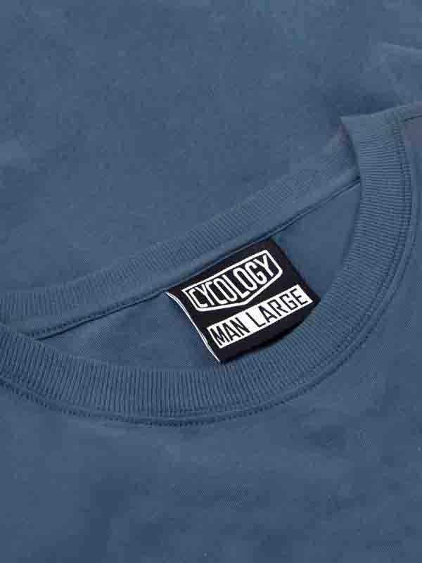 Cycology men's large size tag on blue cycling apparel, showcasing brand label and fit detail