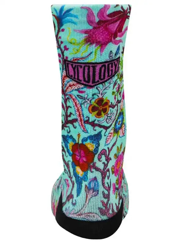 Cycology floral cycling sock with vibrant tropical print and black toe, designed for comfort and style on rides.
