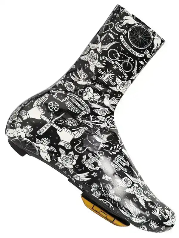 Black cycling shoe cover with white tattoo-style graphics, featuring bikes, roses, and wings for road cycling protection.